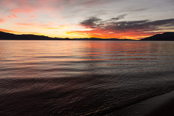 Fototapeta na wymiar Long exposure during sunrise over a large lake