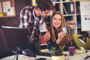 Fototapeta premium Couple of web designers working together at modern office, using