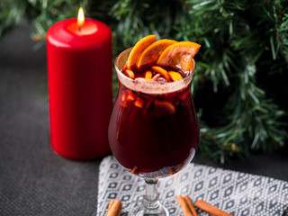 Christmas hot mulled wine with cinnamon, orange and tree on board