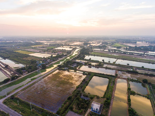 Aerial view of Rice farm with Water Surface and Electicity Tower