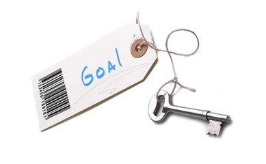 A silver key with a tag attached with a Goal concept written on