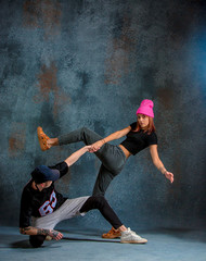 Fototapeta premium The two young girl and boy dancing hip hop in the studio