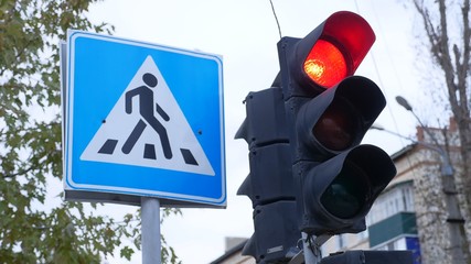 traffic light switches from green to red near the pedestrian crossing sign