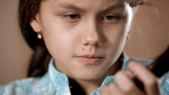 Panorama to hands. Close-up girls face. Girl learning to play mandolin