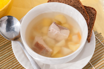  Fish soup in a plate with black bread   