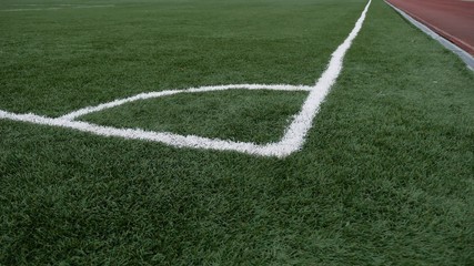 Fototapeta premium football Soccer field corner with green artificial sport grass