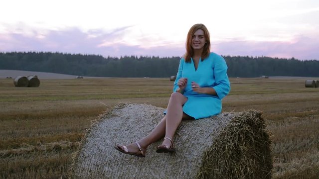 Lovely girl in a blue dress sends a kiss.