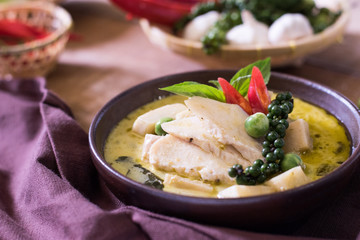 Chicken mussaman curry in bowl vegetables on wooden background