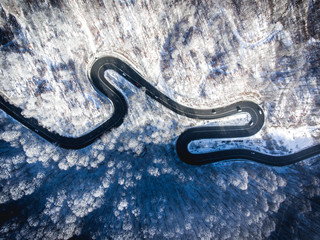 Winding road in the middle of the winter in the high mountain pass 