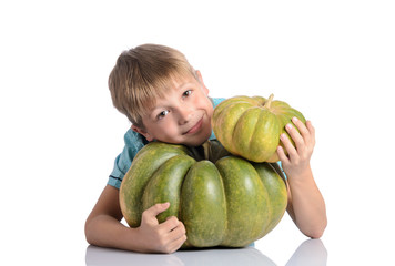 Fototapeta premium Cute boy sitting with different pumpkins