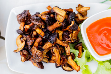fried mushrooms with salt and pepper on white dish