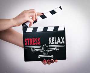 Stress and Relax Balance. Female hands holding movie clapper. 