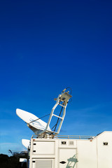 Live broadcast van on a bright dad with the moon on the background