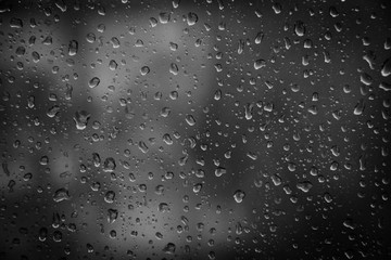 very wet window full of raindrops during rainny.