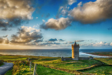 Epic sunset over the wild atlantic way in Doolin County Clare, Ireland. Beautiful scenery landscape with old Irish Castle and coastal beach views.