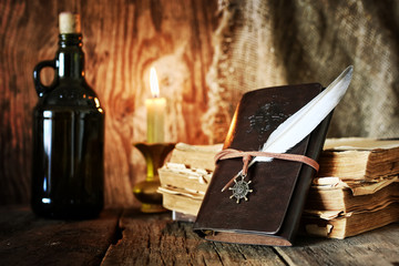 diary and feather with a bottle of rum