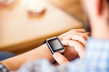Close up of unrecognizable man using smart watch