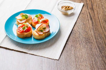 Bruschetta with tomato, cheese and bacon