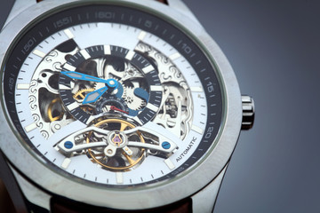 Automatic mechanical skeleton stainless steel men`s watch with leather bracelet close up.