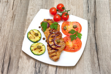 grilled meat with vegetables on a plate