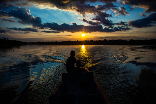 Reflection of the sun at sunset in the Limoncocha lagoon in the Ecuadorian Amazon