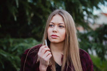 Pretty girl smoking in the park