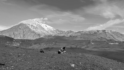Volcano Ostry Tolbachik and Plosky Tolbachic (volcanic bomb in the foreground) - Kamchatka, Russia (black and white) - obrazy, fototapety, plakaty
