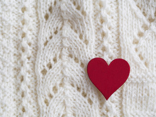 Red heart on a woolen rug.Card on Valentine's Day

