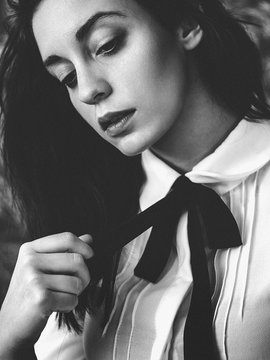Black and white woman holding her tie