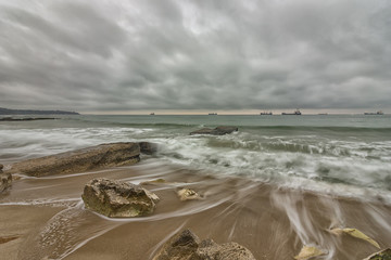 Beauty cloudy, long exposure seascape with slow shutter and waves flowing out.