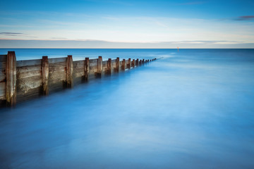 Fototapeta na wymiar Long Exposure of Blyth Beach Groyne, in Northumberland, making it minimalistic, as it enters the North Sea