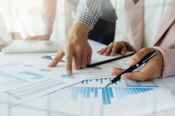 Business concept. Business people discussing the charts and graphs showing the results of their successful teamwork...