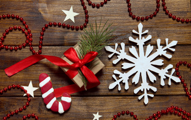 Sugar cane and snow flake on wooden background with presents.