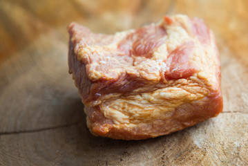 close up on smoked bacon on wood background