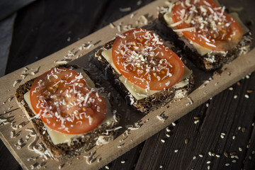 Healthy sandwiches with tomatoes, cheese, sesame and linseed