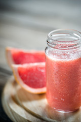 Glass jar of grapefruit smoothie