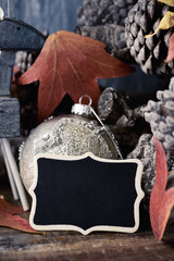 pine cones, christmas ornaments and blank chalkboard