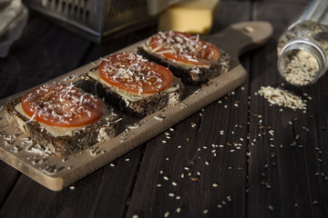 Healthy sandwiches with tomatoes, cheese, sesame and linseed