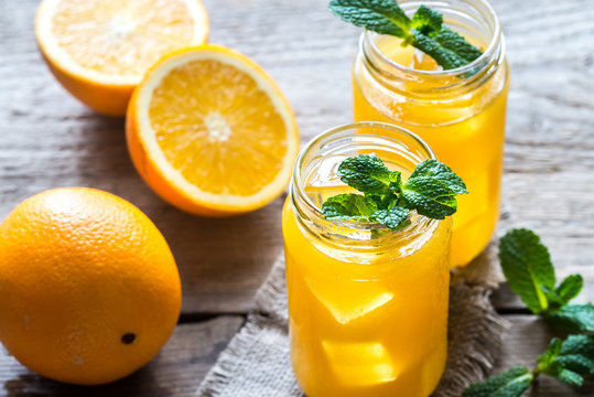 Glass jars of orange juice