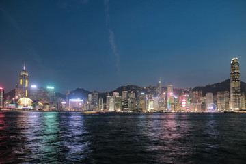 Fototapeta na wymiar ​Hong Kong, China skyline panorama from across Victoria Harbor. Hong Kong city skyline view from harbor with skyscrapers buildings reflect in water at sunset