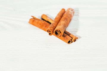several fragrant cinnamon sticks on a white background