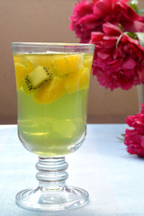 Green jelly - pieces of kiwi, orange in transparent glass