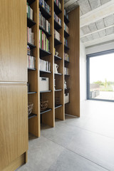 Wooden bookcase in stylish interior