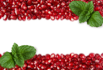 Background made of red pomegranate seeds. The scattered red grains of a pomegranate. Top view.