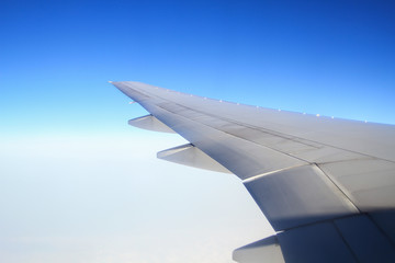 Obraz premium view of the aircraft wing on the sky