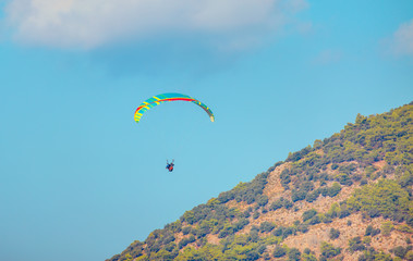 Paraglider doing acrobatic tricks over babadag mountains