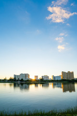 Fototapeta na wymiar Lake in city park with skyline in background