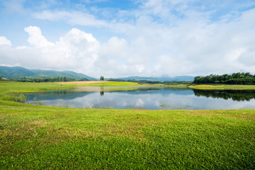 Fototapeta na wymiar grass field with lake