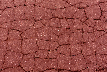 Red toned damaged asphalt texture.