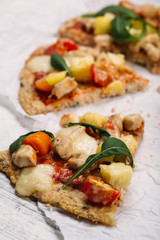 Sliced home made pepperoni pizza on wooden rustic background